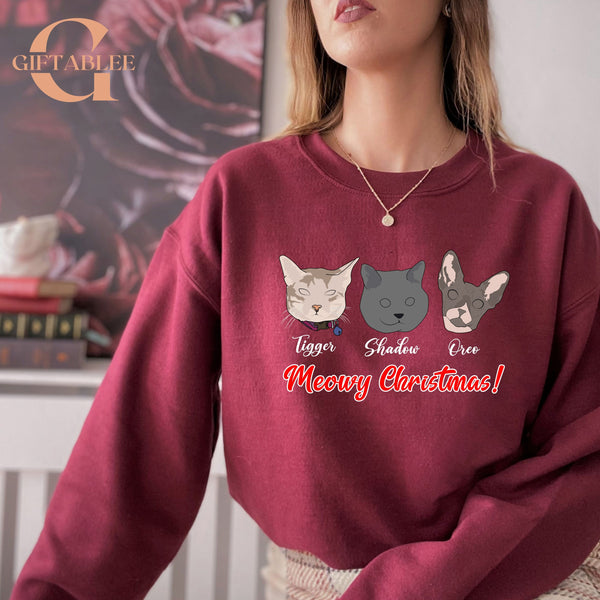 A woman wearing a red sweater with a graphic design featuring three cat faces and the text "Meowy Christmas!"