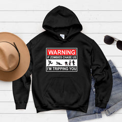 A black hoodie with a humorous graphic design, a pair of sunglasses, and a hat are laid out on a white background.