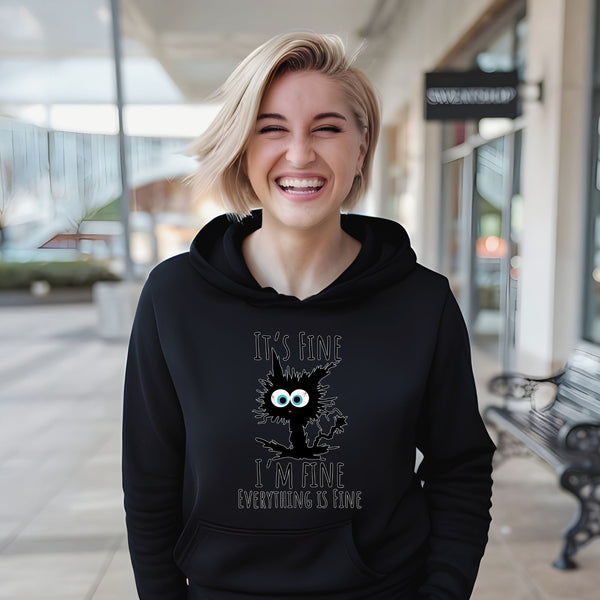 A smiling woman wearing a black hoodie with a cat graphic and text printed on it.