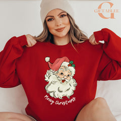 A woman wearing a red sweater with a Santa Claus design and the text "Merry Christmas" is posing for a photo.