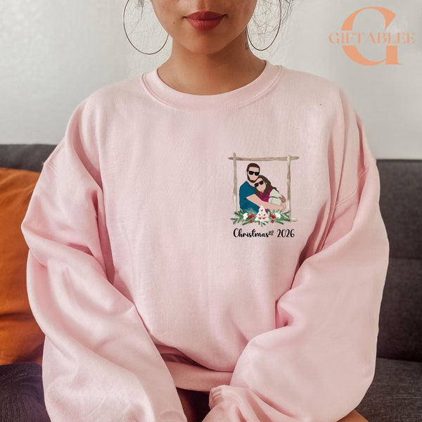 A woman wearing a pink sweater with a graphic design on the front.