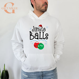 A man wearing a white hoodie with a graphic design that says "Jingle Balls" and features Christmas ornaments.