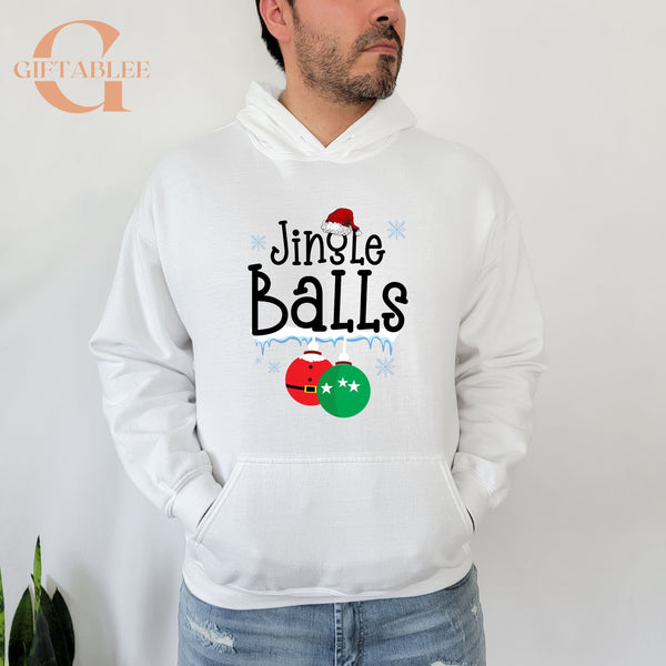 A man wearing a white hoodie with a graphic design that says "Jingle Balls" and features Christmas ornaments.