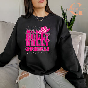 A woman wearing a black sweatshirt with a pink and white design that says "Have a Holly Dolly Christmas".