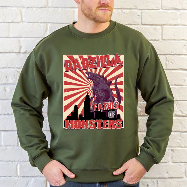 A man wearing a green sweatshirt with a graphic design featuring a large image of a monster and the text "DADZILLA FATHER OF MONSTERS".