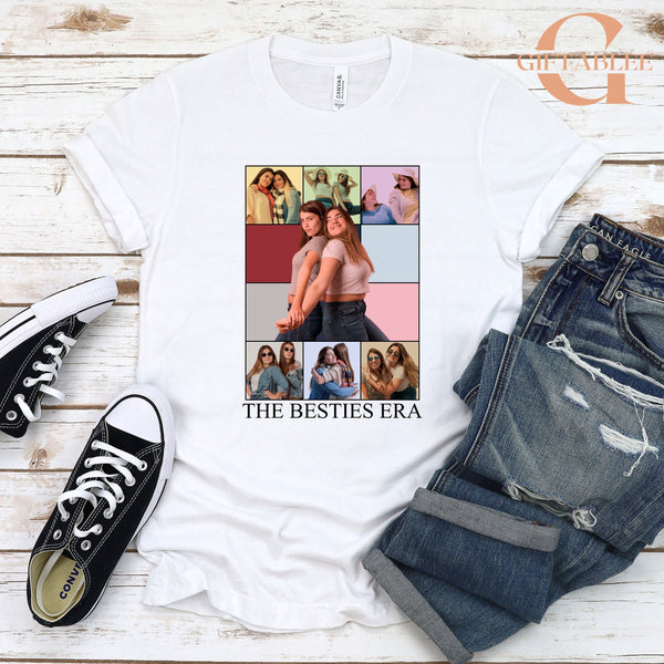 a white t-shirt with a collage of photos of two women, along with a pair of jeans and black and white sneakers.