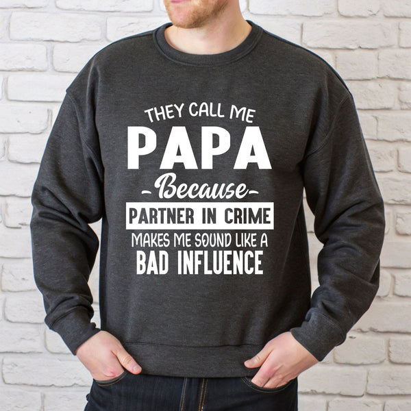 A man wearing a gray sweatshirt with white text printed on it.