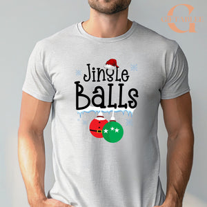 A man wearing a gray t-shirt with a graphic design that says "Jingle Balls" and features Christmas ornaments.