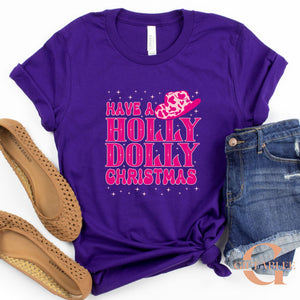 A purple t-shirt with a pink and white design, a pair of brown flat shoes, and a pair of blue denim shorts are arranged on a white background.