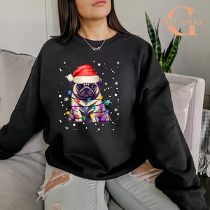 A woman wearing a black sweatshirt with a graphic of a pug wearing a Santa hat and surrounded by Christmas lights.