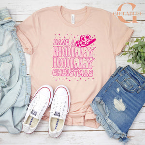 A pink t-shirt with a humorous text, a pair of white sneakers, a denim shirt, and a pair of distressed blue jeans are arranged on a white background.