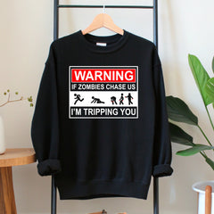 A black sweatshirt with a humorous graphic design on it, hanging on a wooden hanger.