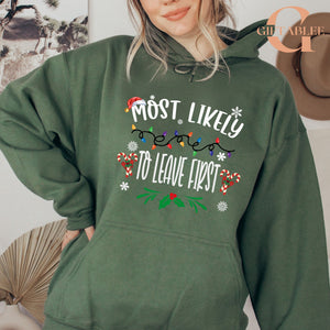A woman wearing a green hoodie with a humorous Christmas-themed text printed on it.