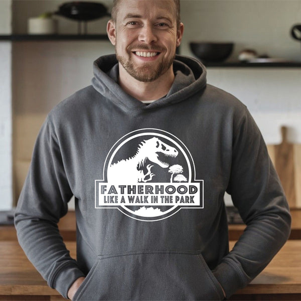 A man wearing a gray hoodie with a graphic design and text printed on it.