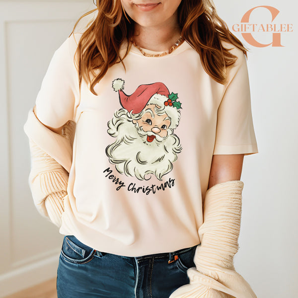 A woman wearing a white t-shirt with a Santa Claus graphic and the text "Merry Christmas" printed on it.