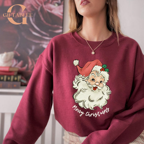 A woman wearing a red sweater with a Santa Claus design and the text "Merry Christmas" printed on it.