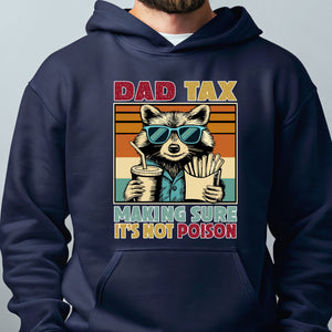 A hoodie with a graphic design featuring a raccoon wearing sunglasses and holding a drink, along with the text "DAD TAX MAKING SURE IT'S NOT POISON".